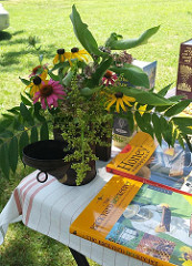photo from beekeeping presentation including flowers and books about bees